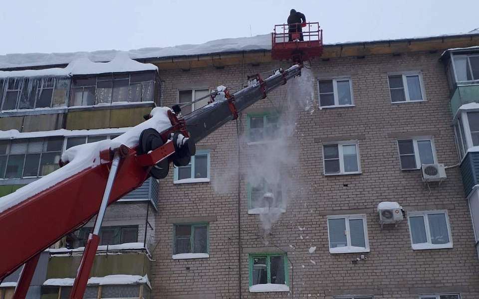 УК Железнодорожного района очищают крыши домов от снега и наледи